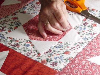 This photo of a woman quilting was taken by an unknown photographer.  Does anyone recognize it? ... a lovely photo.